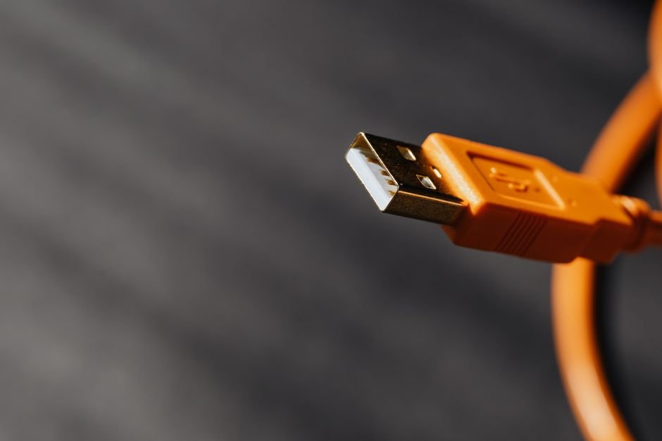 Close-up of USB cables and ports on the back of a desktop PC