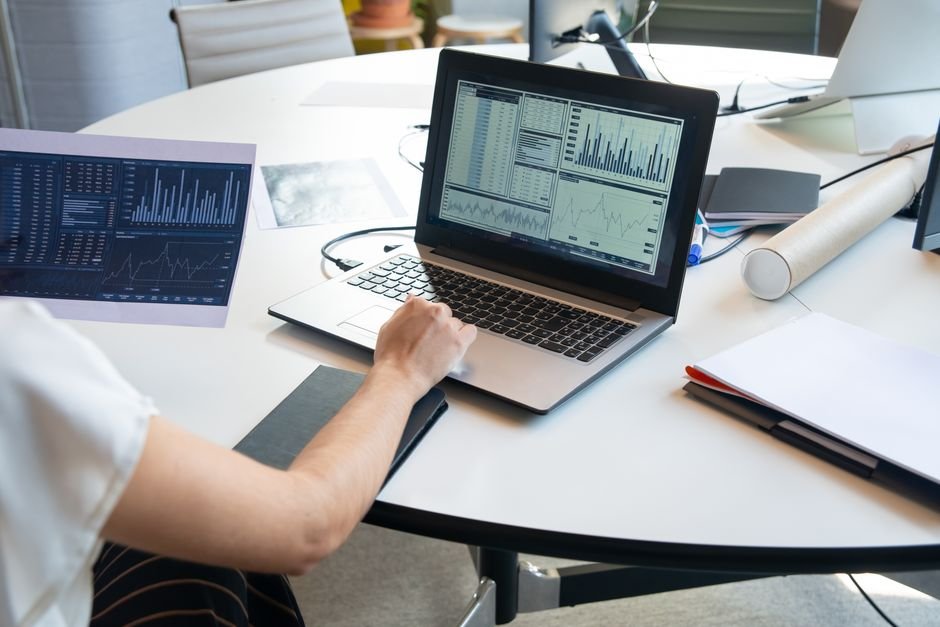 Business person reviewing financial charts on a laptop