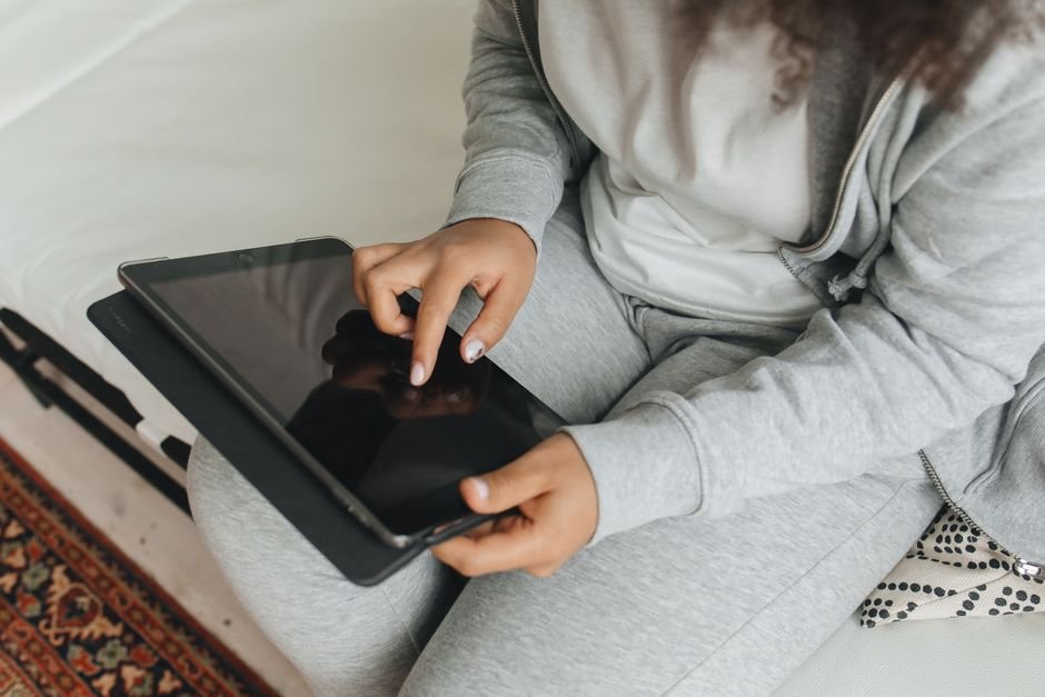 A person using an iPad tablet indoors