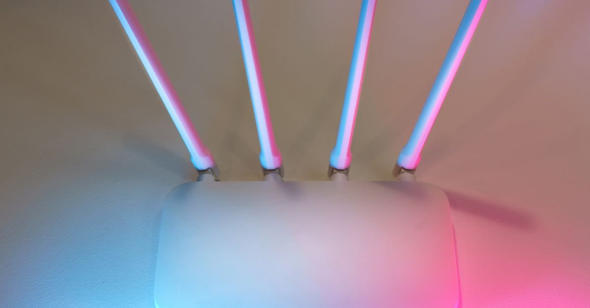 Modern Wi-Fi router on desk with indicator lights
