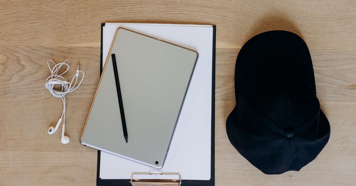 Workplace desk setup with tablet stand and wireless earphones